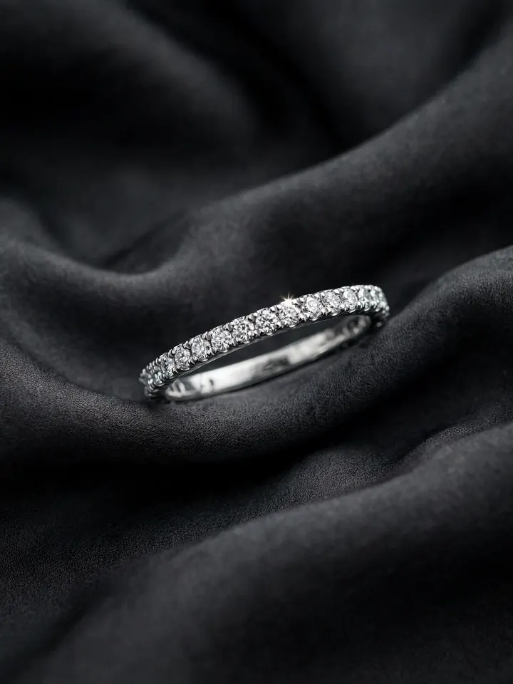 Timeless wedding rings: a platinum full eternity band set with diamonds on dark silk