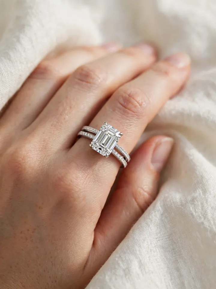 Wedding bands for emerald cut rings — emerald-cut ring sandwiched between two slim diamond wedding bands
